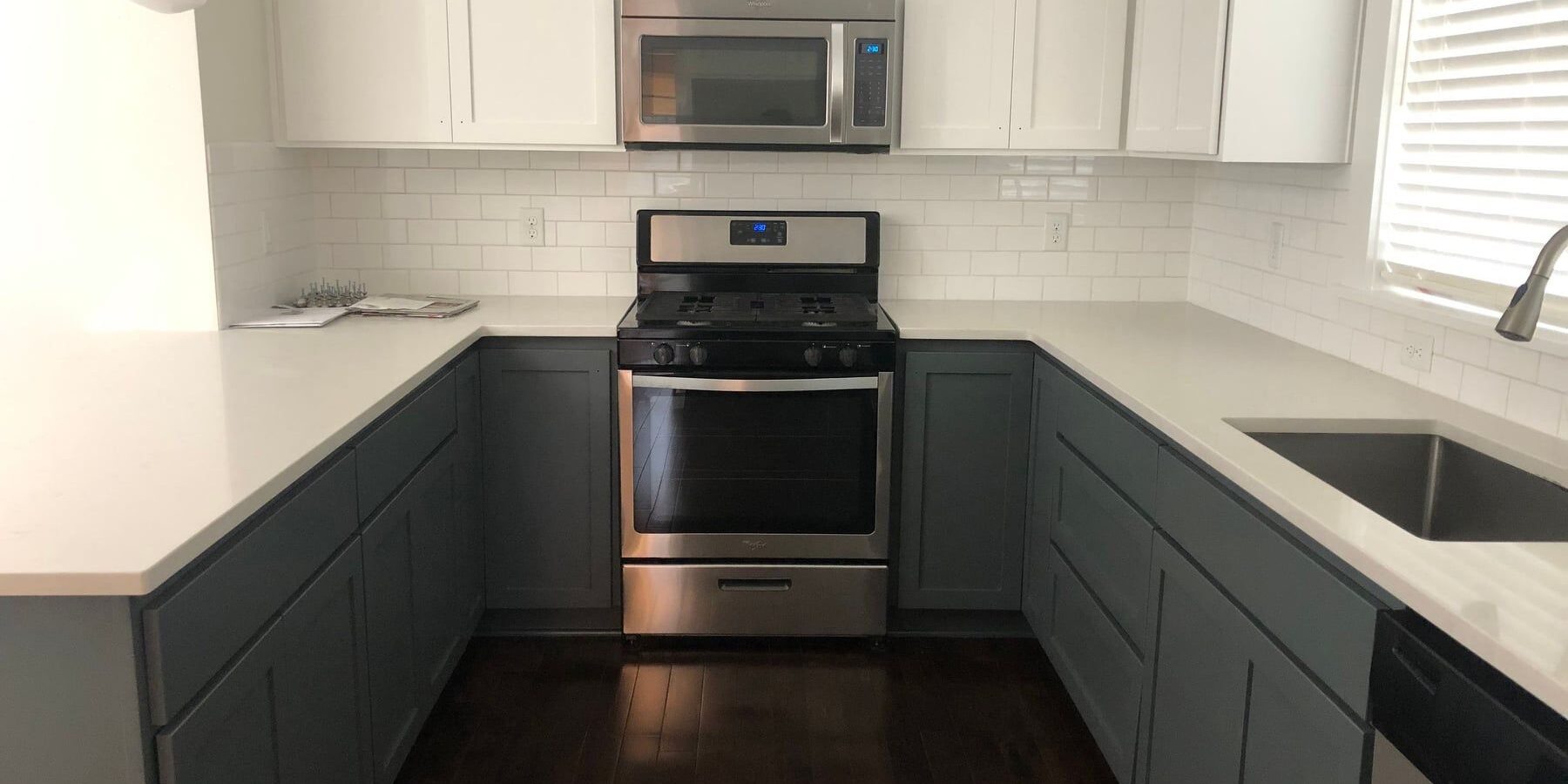 158747302 3930808620274898 1077742906074700241 N Finished kitchen with blue cabinets and white countertops