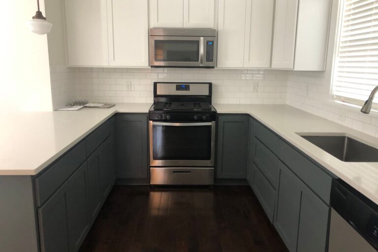 Finished kitchen with blue cabinets and white countertops
