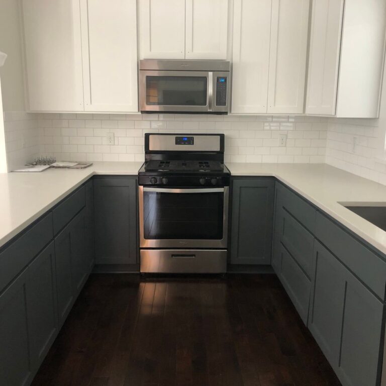 Finished kitchen with blue cabinets and white countertops