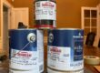 Pile of interior paint cans with Sundeleaf Painting sticker tags