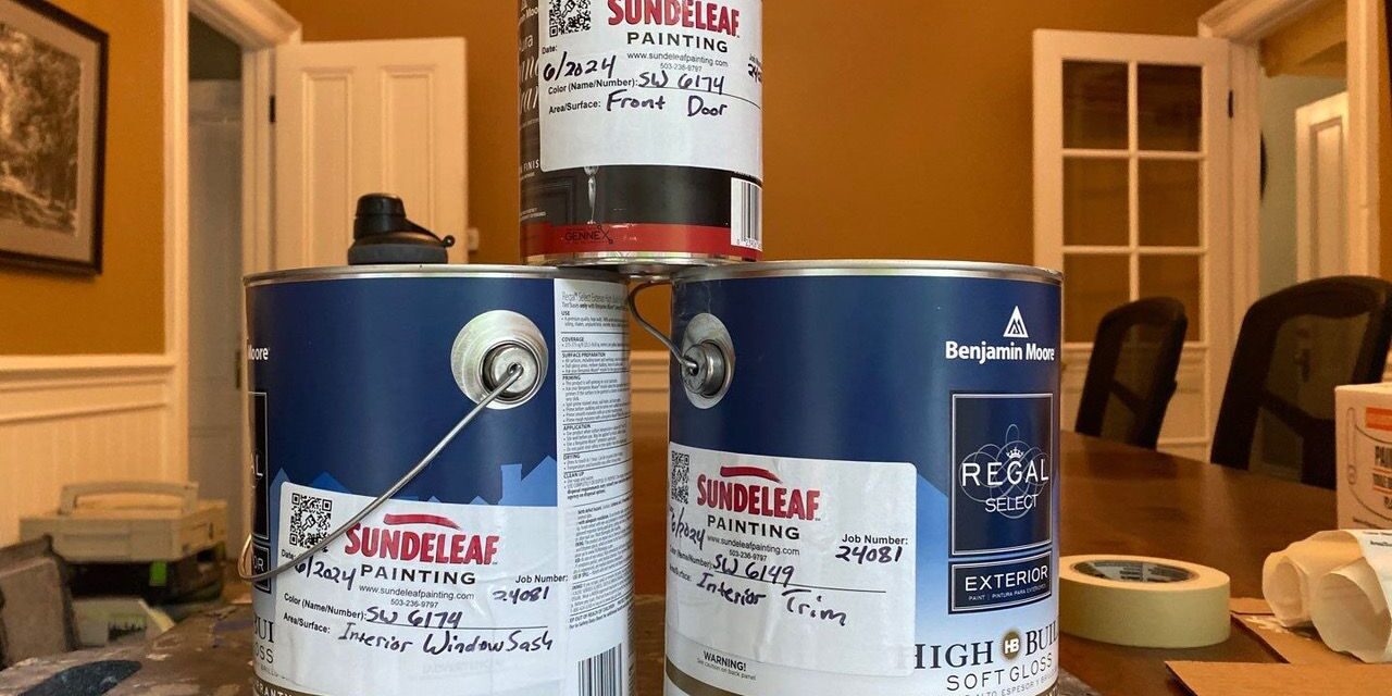 Pile of interior paint cans with Sundeleaf Painting sticker tags