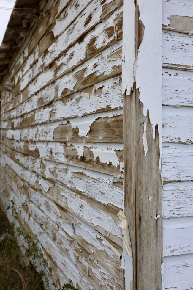 Old Fashioned Wood Barn With Peeling Paint Side of building with peeling paint