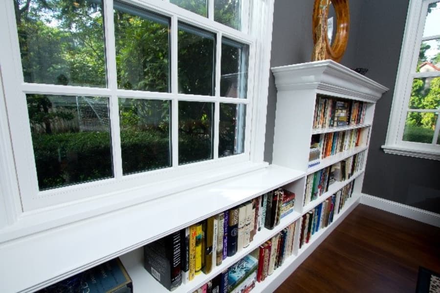 Dark blue room with built-in bookshelves and window