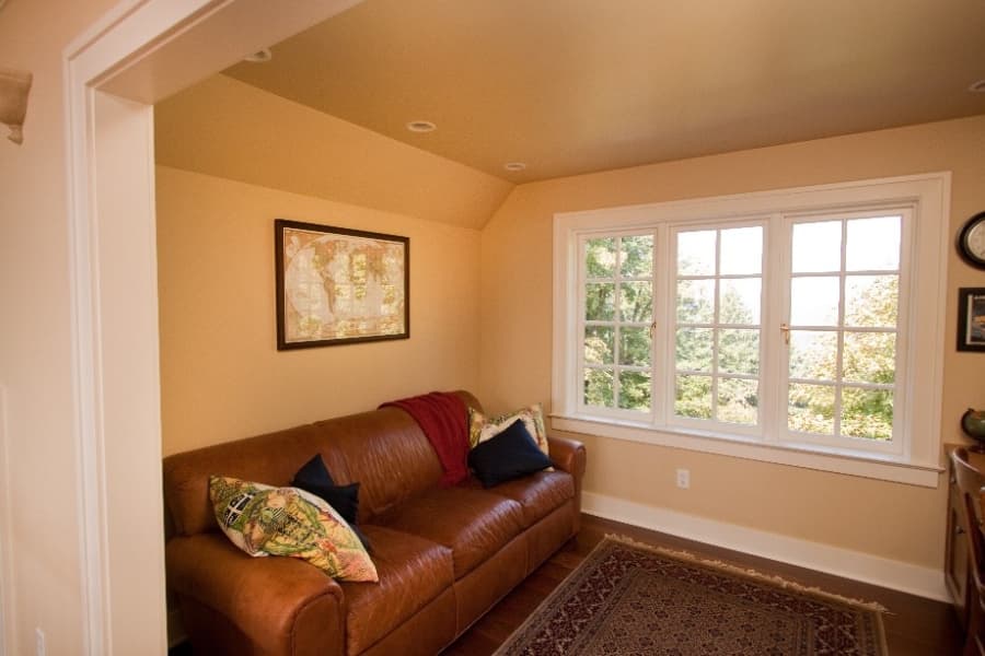 Living Room With Peach Paint And Brown Couch