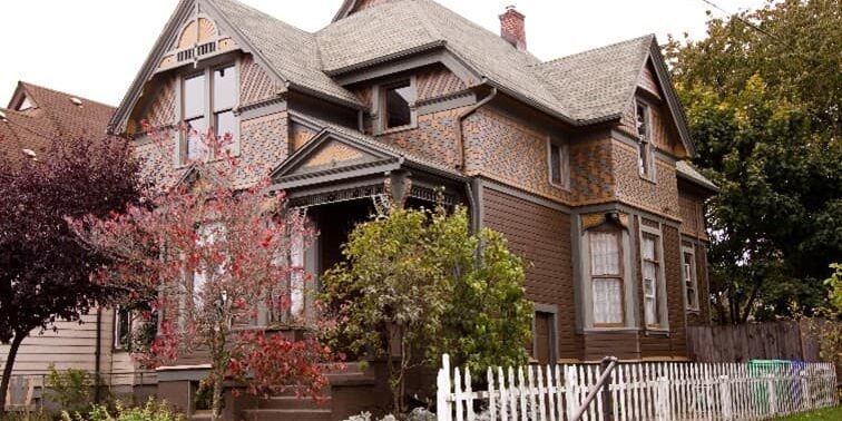 Older House With Brown Details And White Picket Fence Older House With Brown Details And White Picket Fence