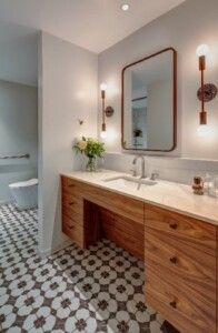 Bathroom With Patterned Floor And Wooden Vanity