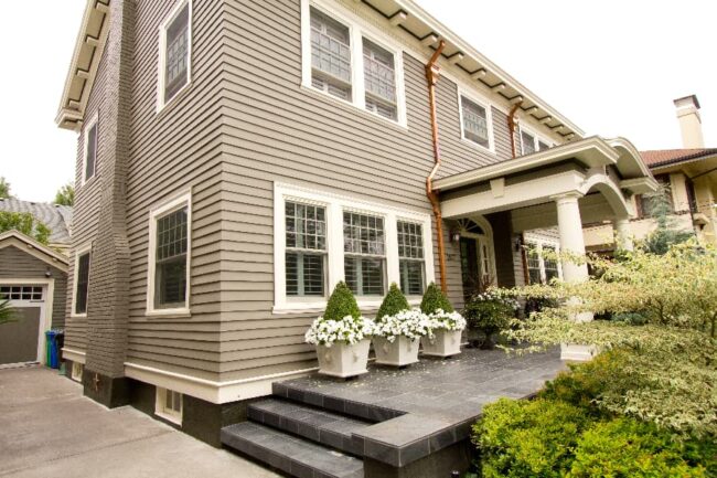 Exterior Of Multilevel Home With Covered Portico And Concrete Entranceway