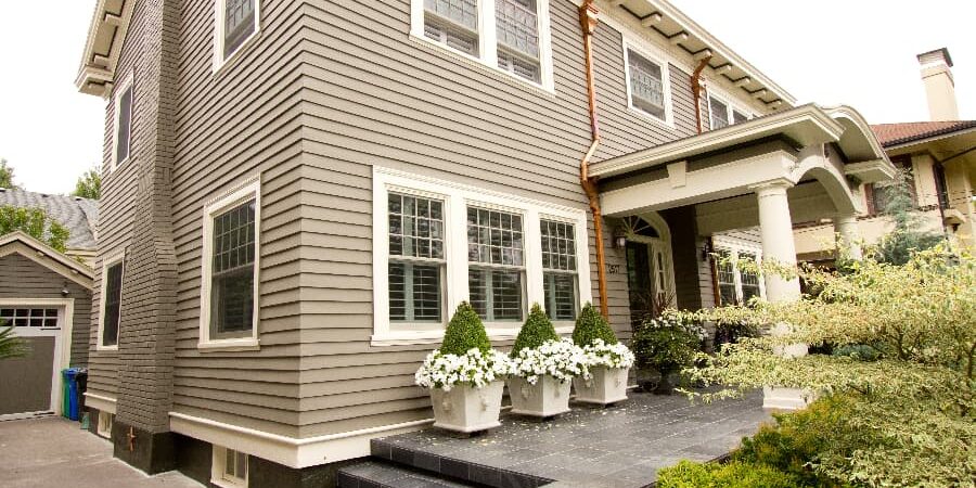 Exterior Of Multilevel Home With Covered Portico And Concrete Entranceway