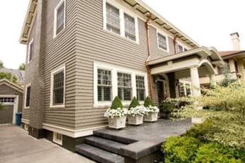 Exterior Of Multilevel Home With Covered Portico And Concrete Entranceway Exterior of multilevel home with covered portico and concrete entranceway