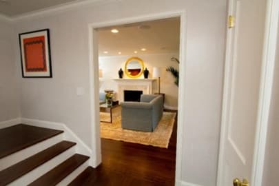 Hardwood hallway and stair landing looking into living room
