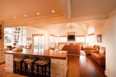 Open-style kitchen with bar seating looking into large living room