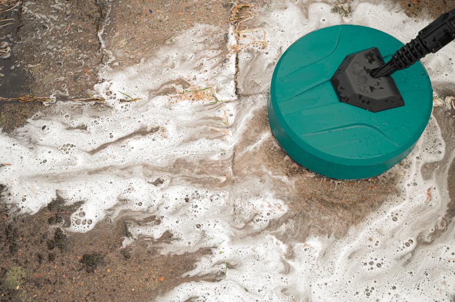 Round Pressure Washer Spraying Foamy Water On Cement Tiles Round Pressure Washer Spraying Foamy Water On Cement Tiles