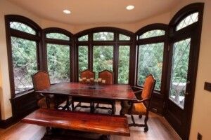Dining Table In Bay Window With Natural Wood Trim