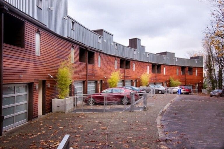 Row Of Townhouses With Clean Asphalt And Siding