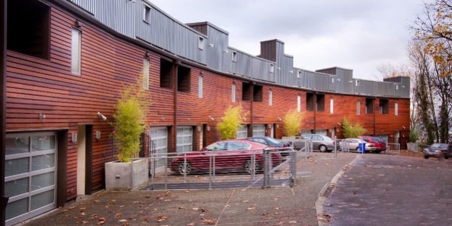 Row Of Townhouses With Clean Asphalt And Siding