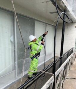 Sundeleaf Painting Employee Power Washing Building Exterior