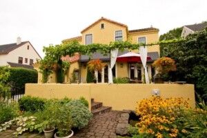Large Yellow House With Cobblestone Steps And Garden