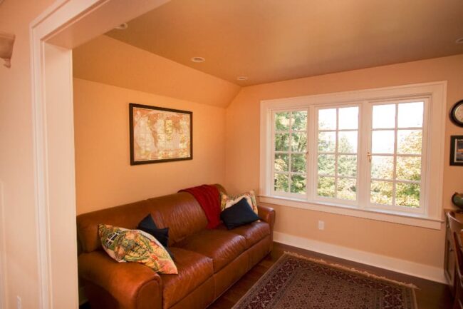 Living Room Interior With Yellow Paint And Brown Couch
