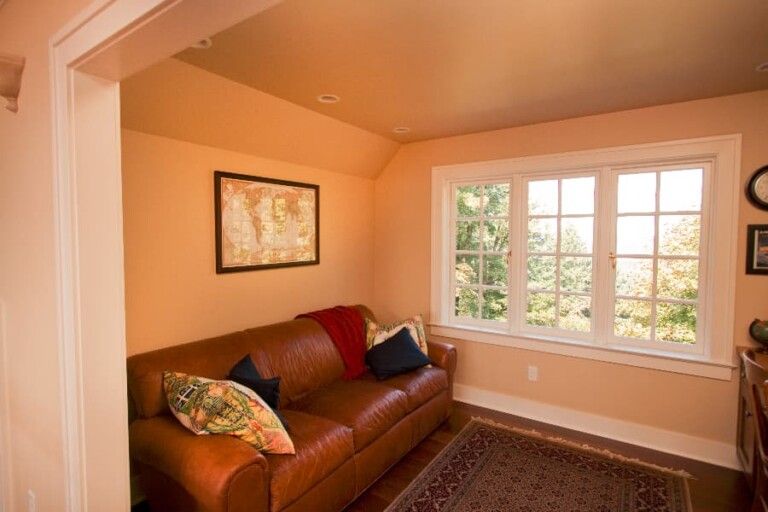 Living Room Interior With Yellow Paint And Brown Couch